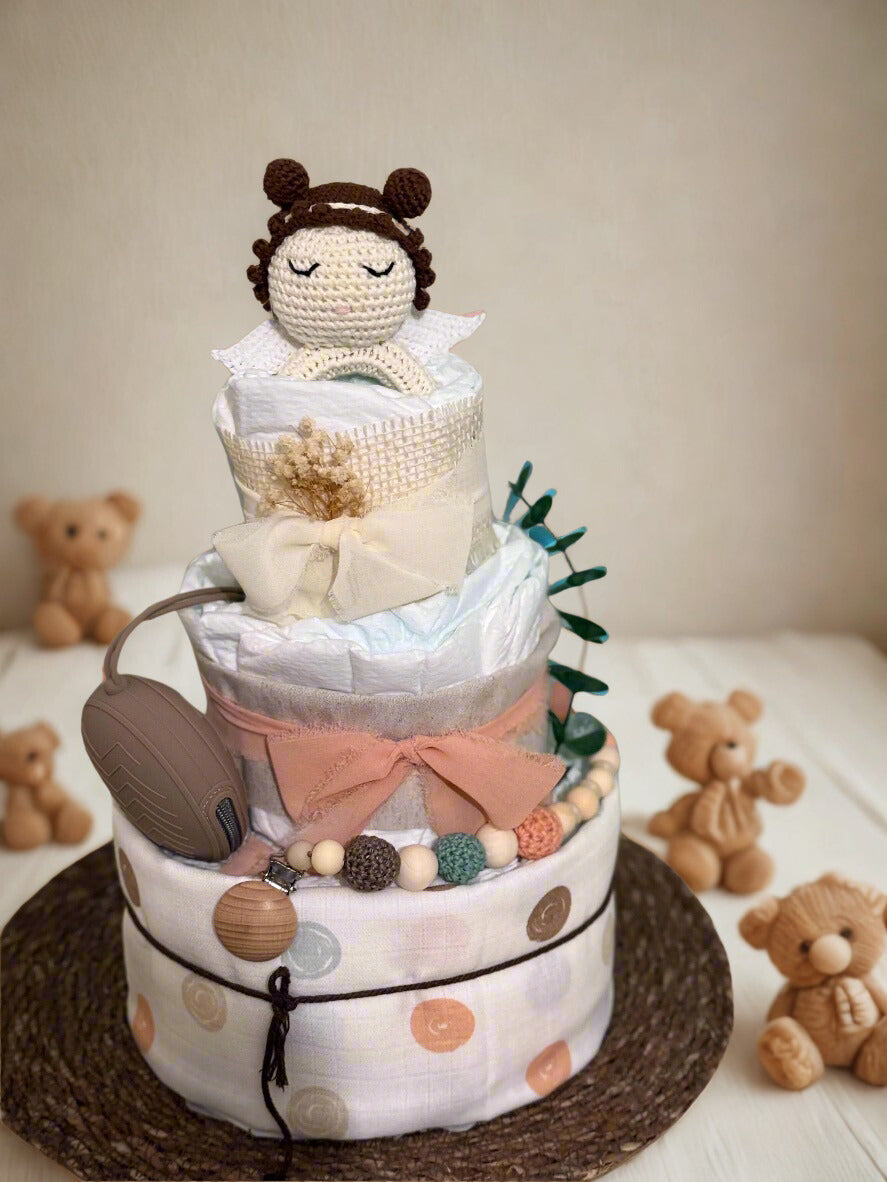 Safari giraffe diaper cake baby shower centerpiece designed in soft yellow, cream, and natural burlap tones. This three-tier arrangement features rolled white diapers wrapped in warm pastel yellow fabric at the base and finished with a delicate gray twine bow for a charming rustic touch.

The middle tier is wrapped in natural burlap ribbon and tied with an elegant ivory satin bow, complemented by a coordinating silicone and crochet beaded pacifier clip in mustard, cream, and soft gray hues. A matching neutr